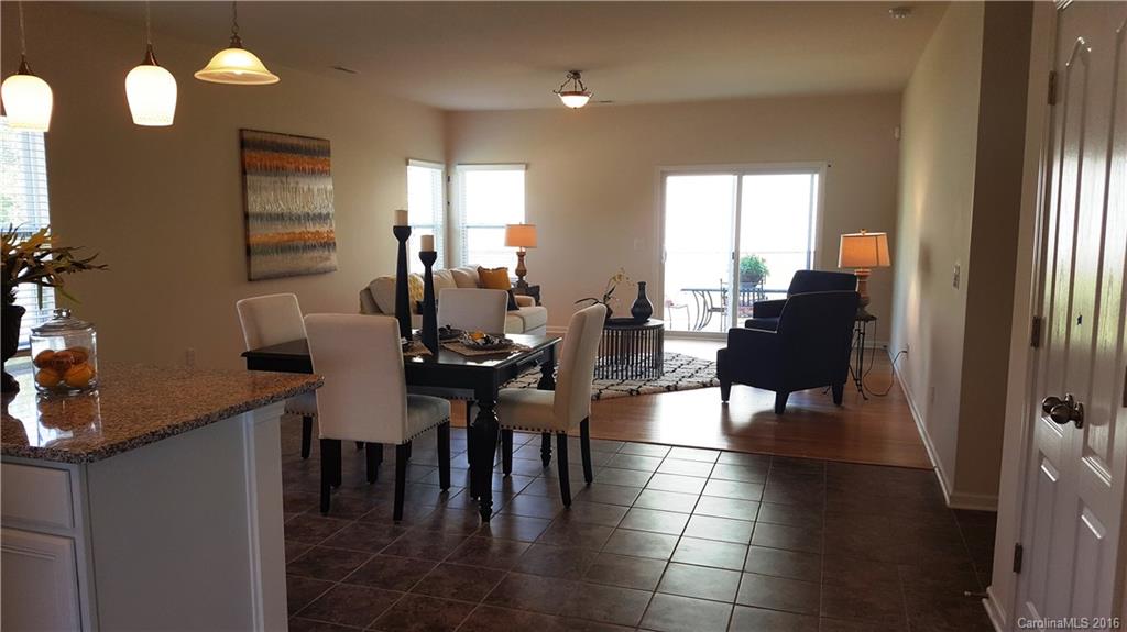 1628 Spring Blossom Trail, Unit SITE 18 Fort Mill, SC 29708 - Photo 7 of 22 a view of a dining room with furniture and chandelier
