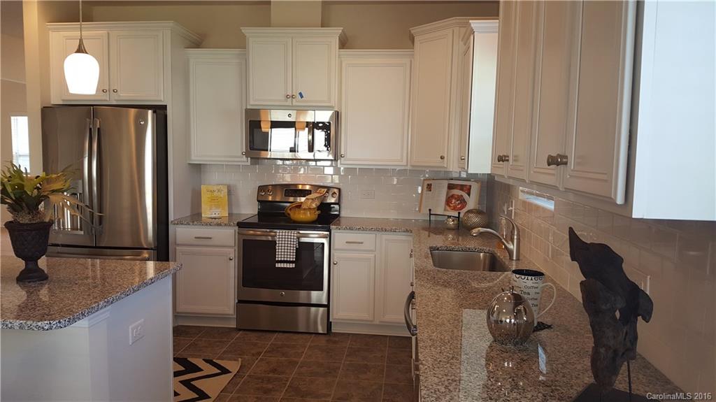 1628 Spring Blossom Trail, Unit SITE 18 Fort Mill, SC 29708 - Photo 8 of 22 a kitchen with a sink cabinets and appliances