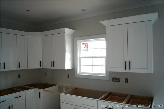 a kitchen with cabinets and window