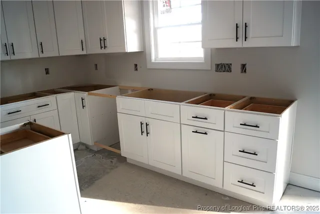 a utility room with cabinets washer and dryer