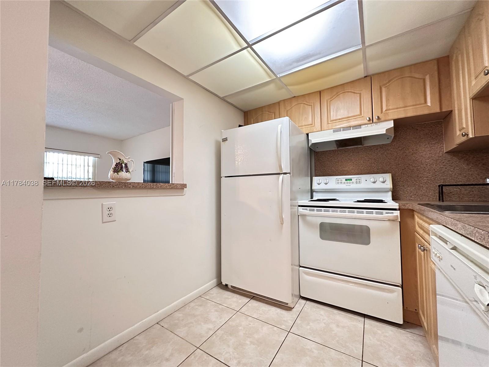 569 Fanshaw North, Unit 569 Boca Raton, FL 33434 - Photo 11 of 22 a white refrigerator freezer sitting in a kitchen