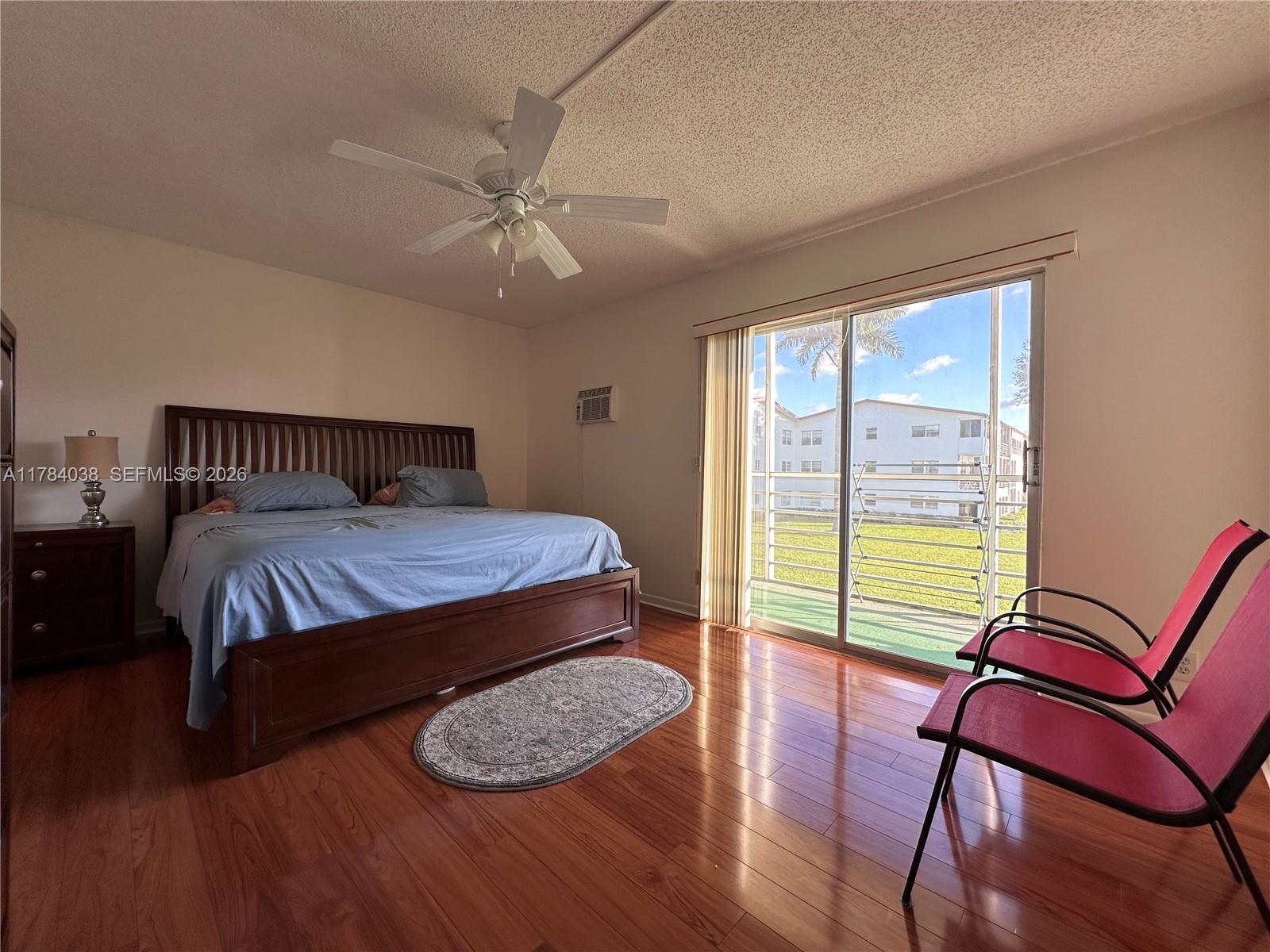 569 Fanshaw North, Unit 569 Boca Raton, FL 33434 - Photo 15 of 22 a bedroom with a bed and wooden floor