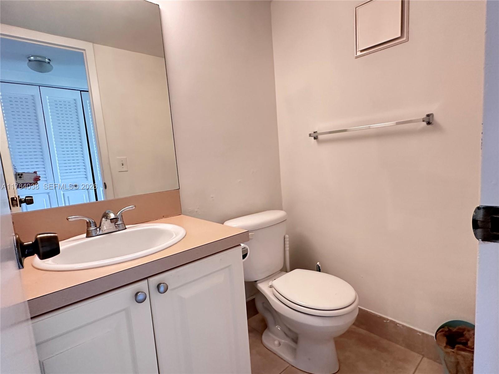 569 Fanshaw North, Unit 569 Boca Raton, FL 33434 - Photo 19 of 22 a bathroom with a sink a toilet and mirror