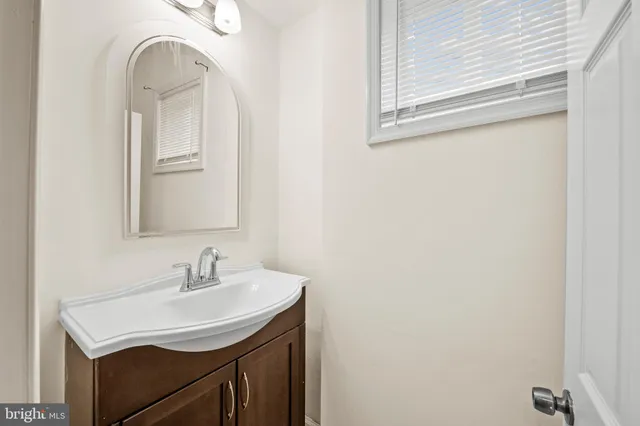 a bathroom with a sink a mirror and vanity