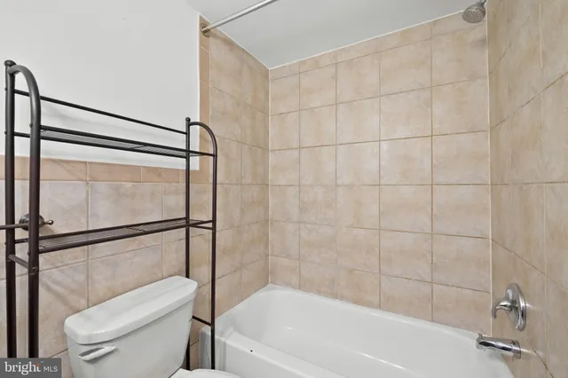 a bathroom with a toilet and a bathtub