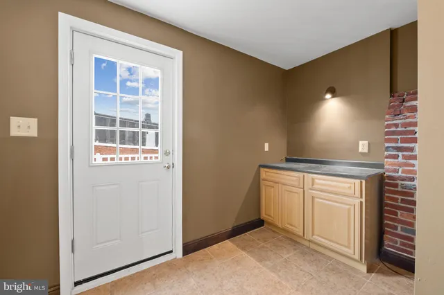 a view of an empty room with a fireplace