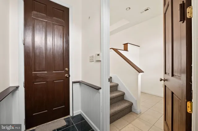 a view of entryway with hallway and stairs