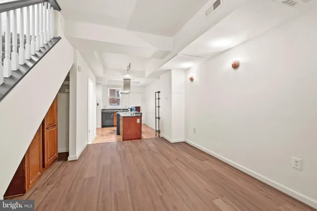 a view of a kitchen with wooden floor and electronic appliances