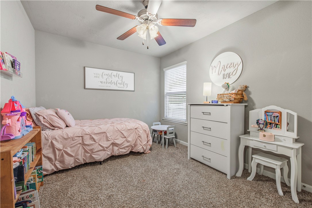 3014 Positano Loop Bryan, TX 77808 - Photo 16 of 23 a bedroom with a bed and a chandelier
