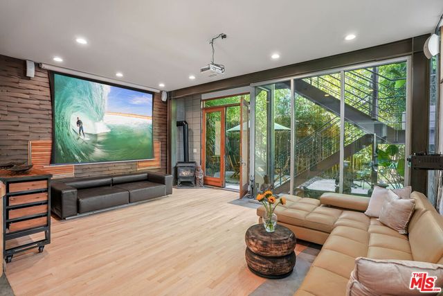 a living room with furniture large windows and a flat screen tv