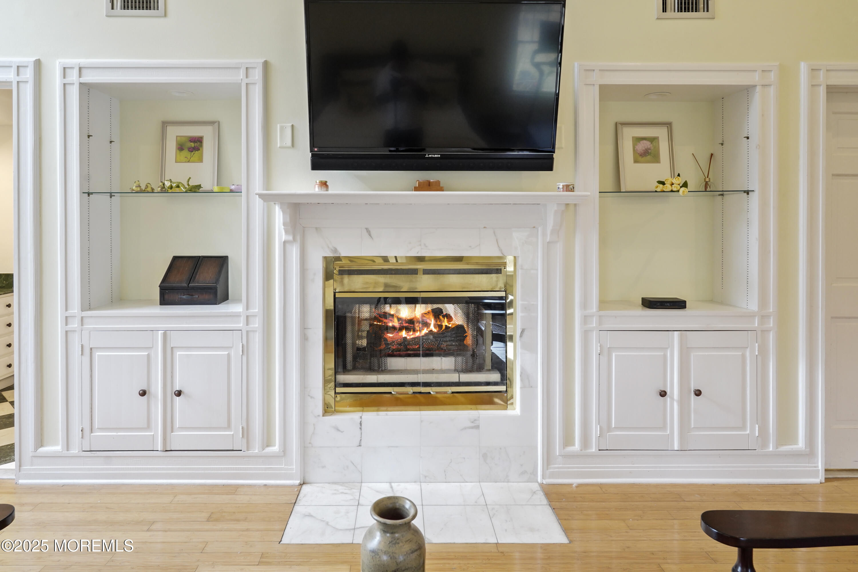 43 Rumson Road Rumson, NJ 07760 - Photo 19 of 28 a living room with a fireplace and a flat screen tv
