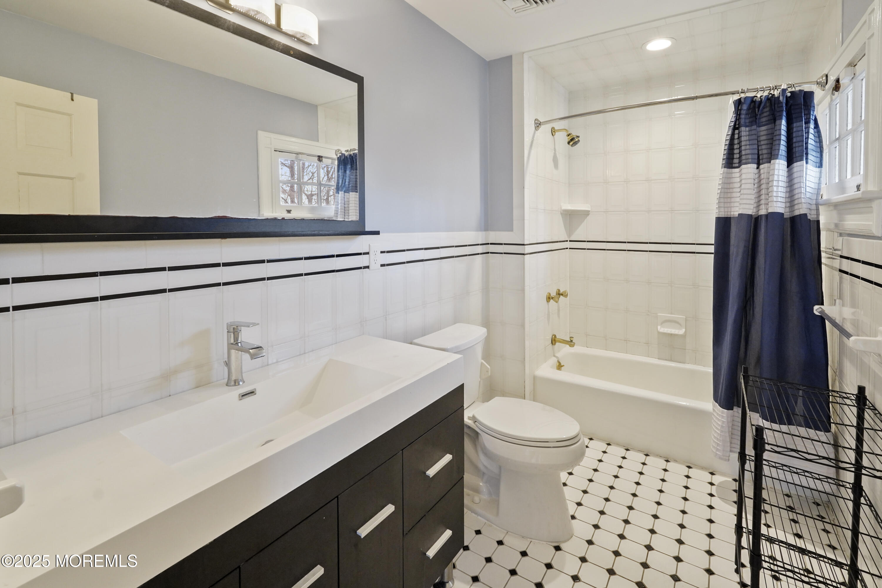 43 Rumson Road Rumson, NJ 07760 - Photo 26 of 28 a bathroom with a sink a toilet a shower and a mirror