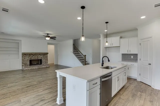 a kitchen with a sink appliances and cabinets