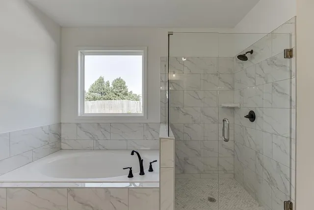 a white bath tub sitting next to a window
