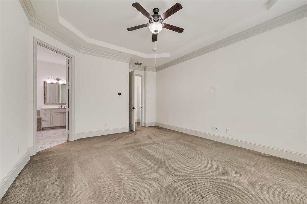 2021 Calisto Way Allen, TX 75013 - Photo 20 of 34 Spacious room featuring tray ceiling, crown molding, gray trim, ceiling fan with integrated lighting, and carpet flooring