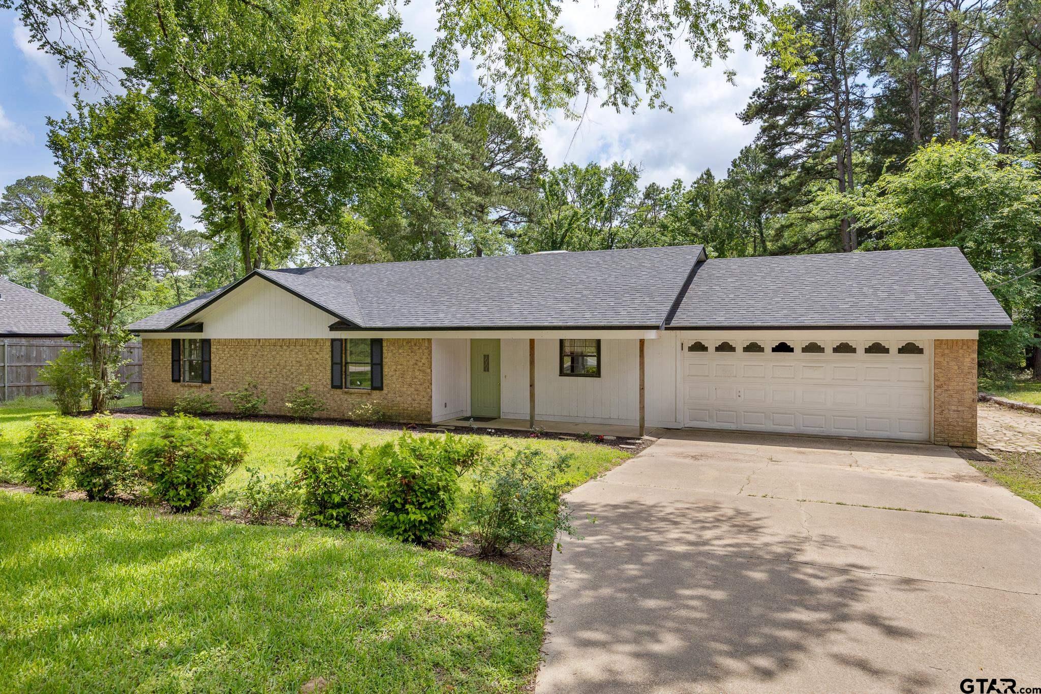 16780 Wilson Road Tyler, TX 75707 - Photo 1 of 24 a front view of a house with a yard and garage