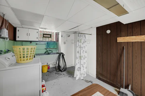 a view of storage and utility room with a window