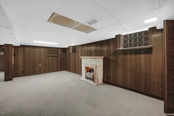 a view of a livingroom with an empty space and a fireplace