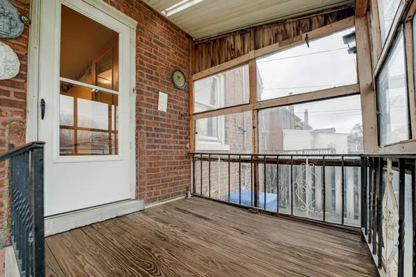 a view of a balcony with wooden floor and fence