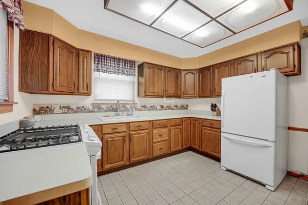 a kitchen with granite countertop appliances a sink and cabinets