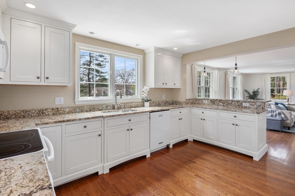32 Howland Lane Hingham, MA 02043 - Photo 13 of 40 a kitchen with granite countertop white cabinets sink and window