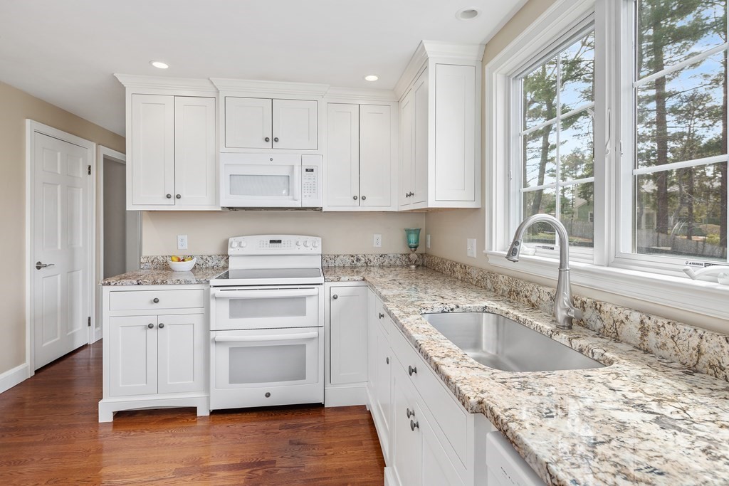 32 Howland Lane Hingham, MA 02043 - Photo 15 of 40 a kitchen with granite countertop white cabinets and white appliances