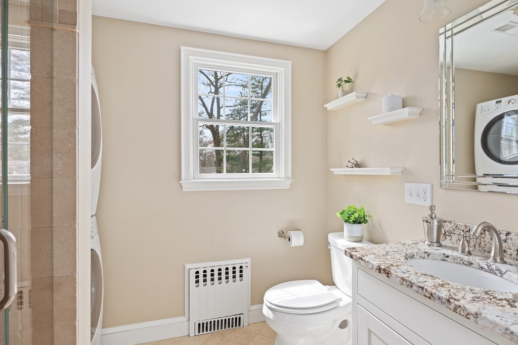 32 Howland Lane Hingham, MA 02043 - Photo 19 of 40 a bathroom with a granite countertop toilet sink and mirror