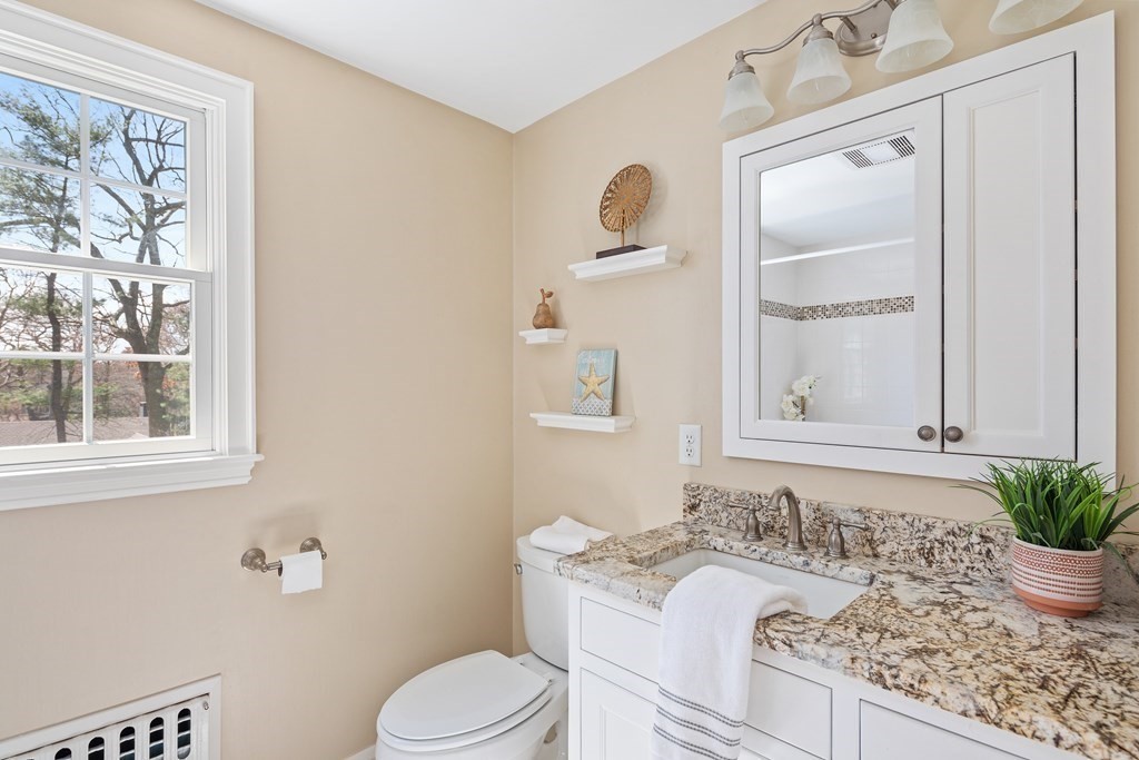 32 Howland Lane Hingham, MA 02043 - Photo 23 of 40 a bathroom with a granite countertop sink and a mirror