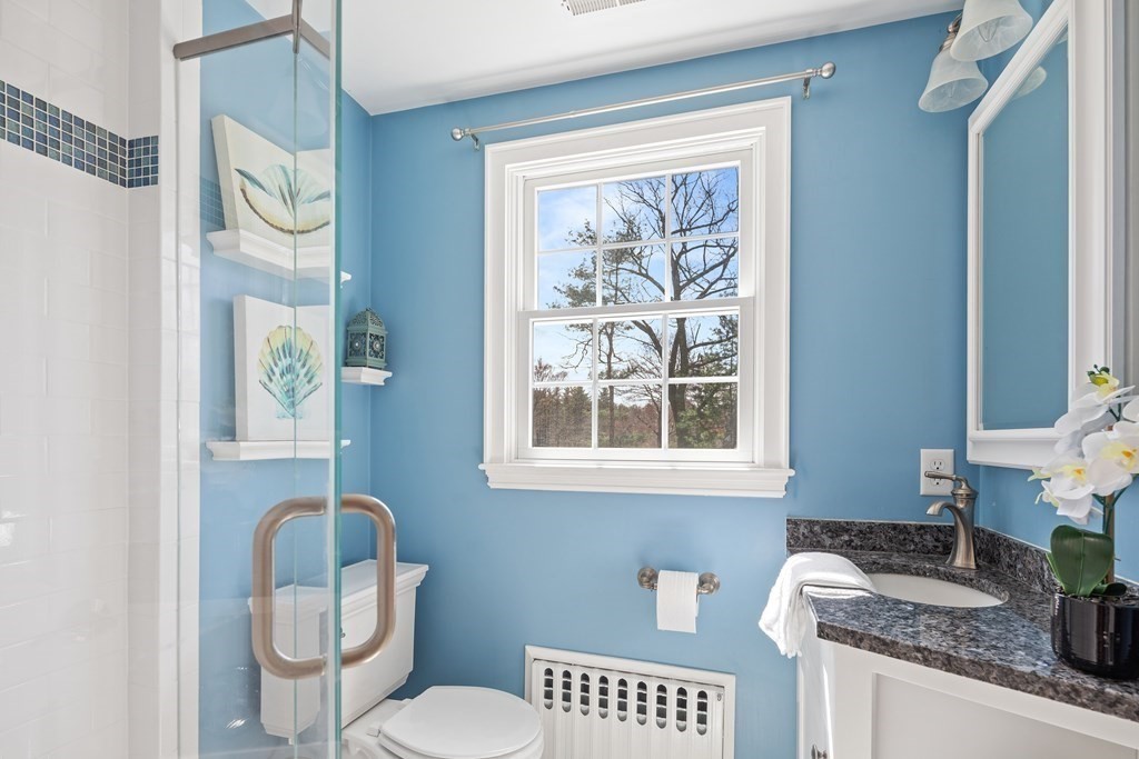 32 Howland Lane Hingham, MA 02043 - Photo 30 of 40 a bathroom with a granite countertop toilet sink and mirror