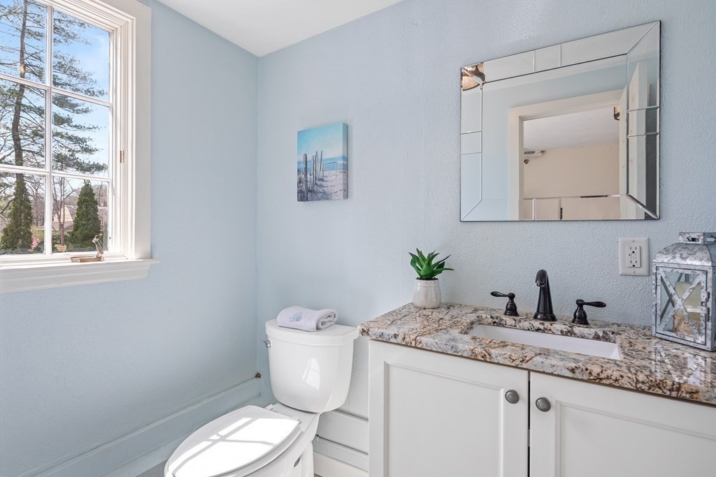 32 Howland Lane Hingham, MA 02043 - Photo 34 of 40 a bathroom with a granite countertop toilet sink and mirror