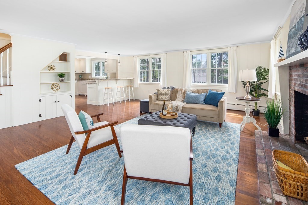 32 Howland Lane Hingham, MA 02043 - Photo 7 of 40 a living room with furniture wooden floor and a fireplace