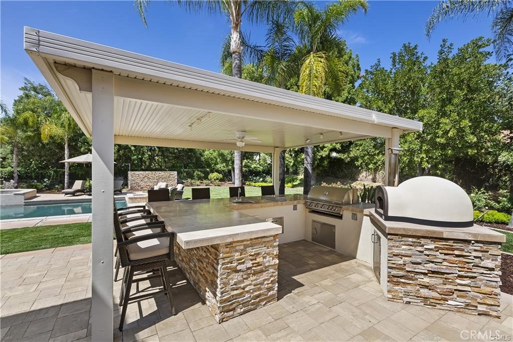 1623 Northhampton Drive Riverside, CA 92506 - Photo 11 of 59 a view of outdoor dining space with a patio and a yard
