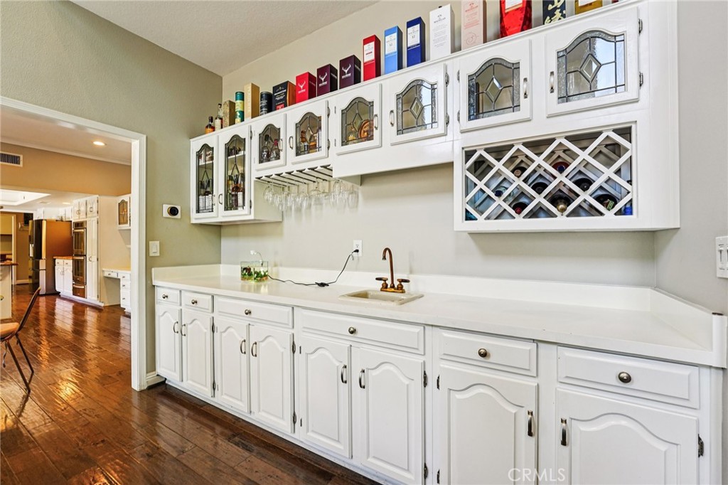 1623 Northhampton Drive Riverside, CA 92506 - Photo 26 of 59 a kitchen with cabinets and wooden floor
