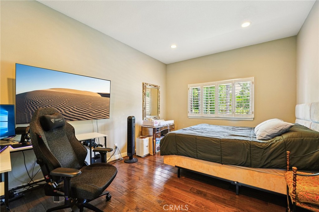1623 Northhampton Drive Riverside, CA 92506 - Photo 29 of 59 a bedroom with a bed and a chair