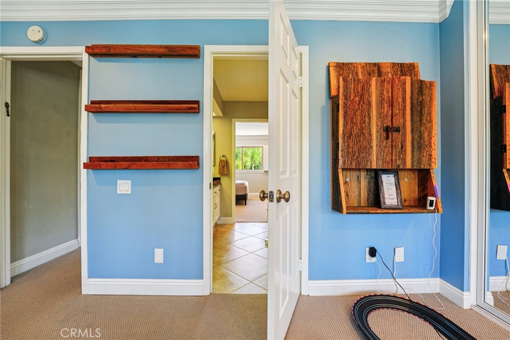 1623 Northhampton Drive Riverside, CA 92506 - Photo 36 of 59 a bathroom with a granite countertop sink and a mirror