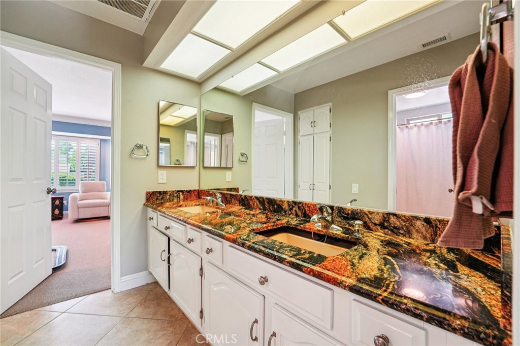 1623 Northhampton Drive Riverside, CA 92506 - Photo 37 of 59 a bathroom with a sink and a mirror