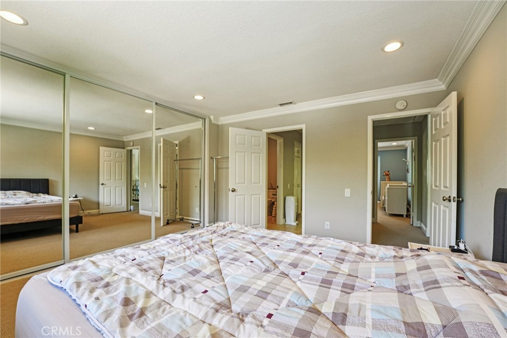 1623 Northhampton Drive Riverside, CA 92506 - Photo 40 of 59 a bedroom with a bed and a large mirror