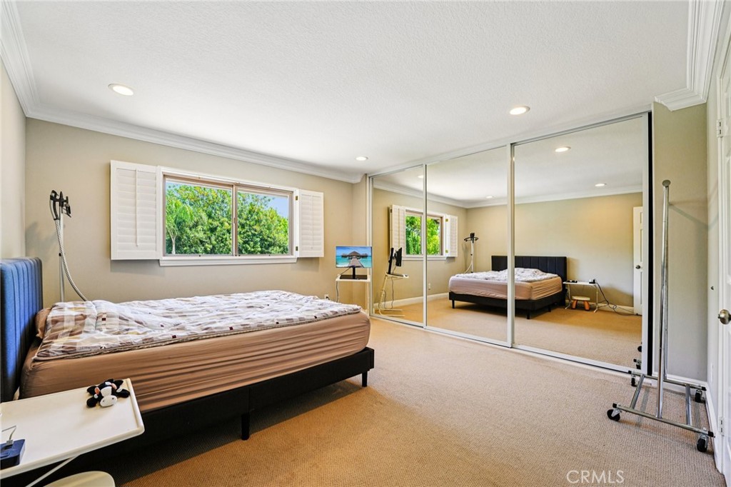 1623 Northhampton Drive Riverside, CA 92506 - Photo 41 of 59 a bedroom with a bed and large window