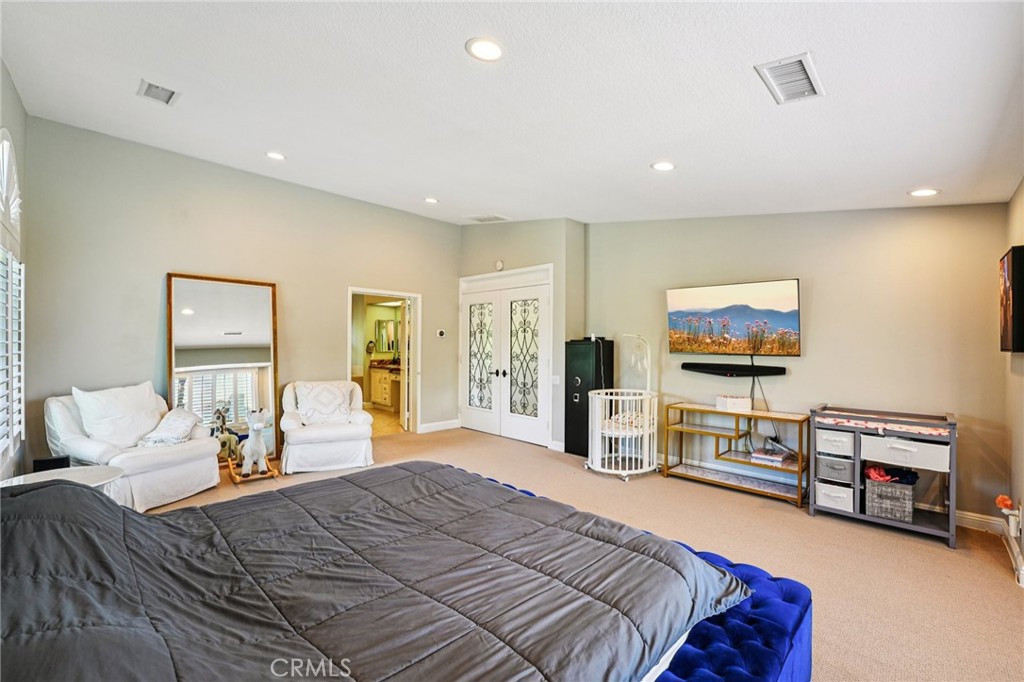 1623 Northhampton Drive Riverside, CA 92506 - Photo 43 of 59 a bedroom with furniture and a flat screen tv