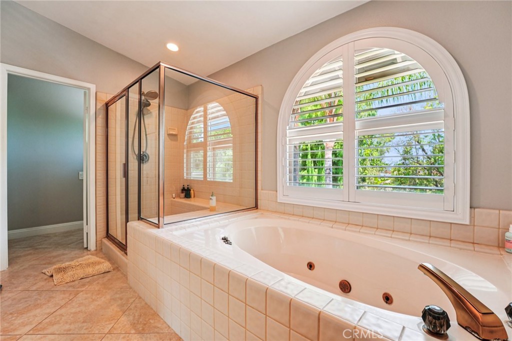 1623 Northhampton Drive Riverside, CA 92506 - Photo 44 of 59 a bathroom with a tub a sink and a large window