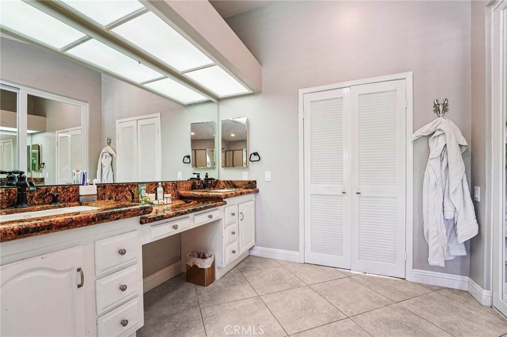 1623 Northhampton Drive Riverside, CA 92506 - Photo 46 of 59 a spacious bathroom with a double vanity sink a mirror and a shower