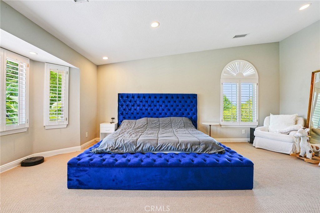 1623 Northhampton Drive Riverside, CA 92506 - Photo 47 of 59 a spacious bedroom with a bed and a large window