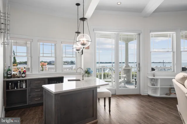 a kitchen with kitchen island a stove a sink and a counter space
