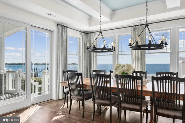 a dining room with furniture and wooden floor