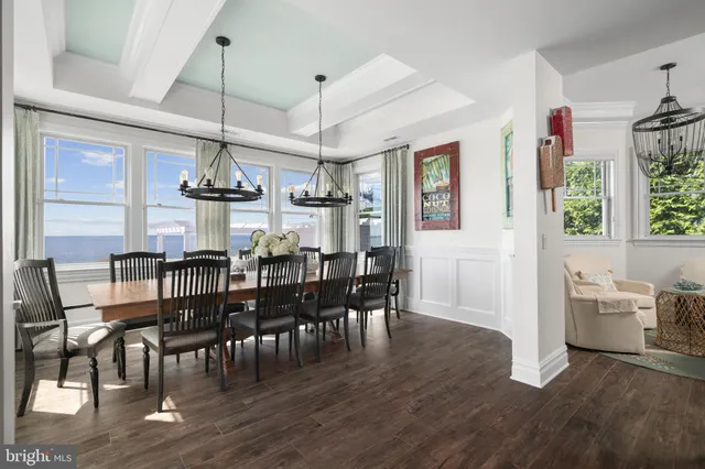 a living room with stainless steel appliances kitchen island granite countertop a sink and a stove