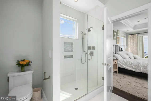 a spacious bathroom with a tub shower and windows