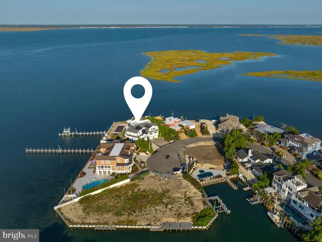 a living room with furniture and large windows