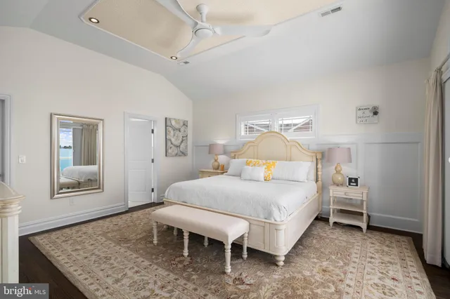 a bathroom with a granite countertop sink mirror vanity bathtub and a toilet