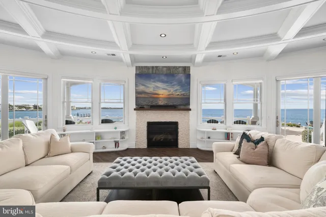 a kitchen with granite countertop a stove a sink a refrigerator and a wooden floor