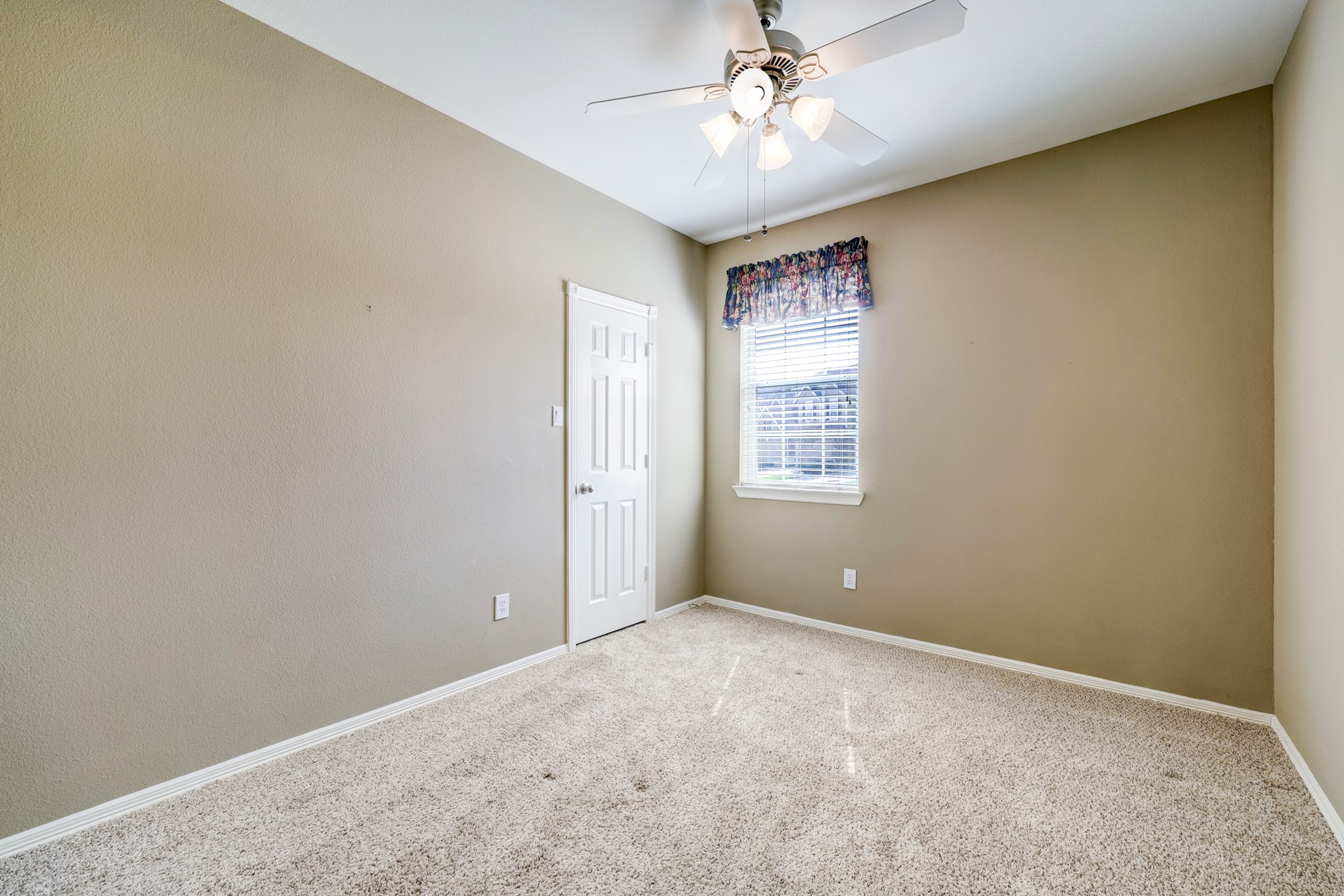 18618 Jaya Loch Court Spring, TX 77379 - Photo 13 of 18 an empty room with windows and fan